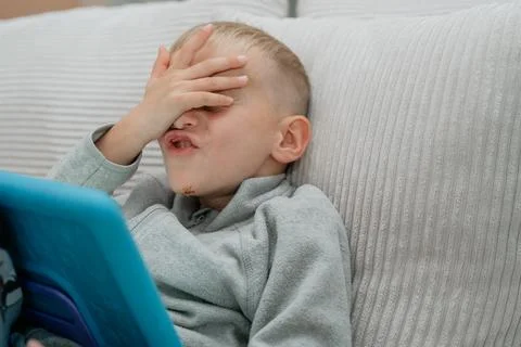 Boy Facepalm with Tablet Fotos de archivo