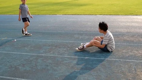 Boy fall and help by another boy Stock Footage 72485234