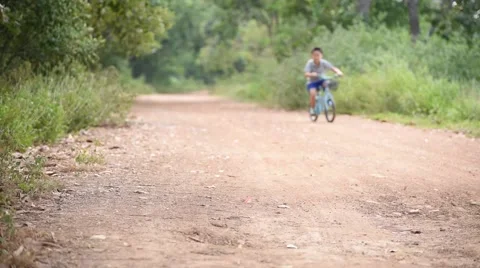 Boy fall from the bicycle during ride on the road and stand up by himself Stock Footage 57896406