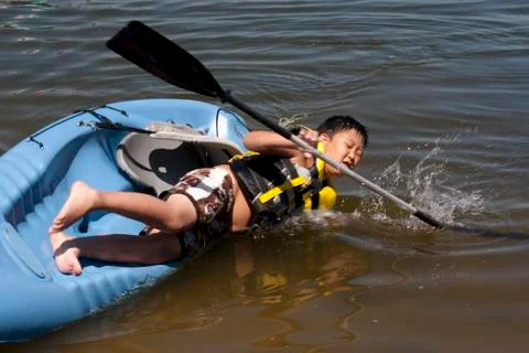 Boy falling off a kayak Fotos de archivo