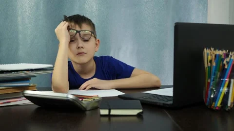 The boy falls asleep sitting at the table. study at home Stock Footage 144935055