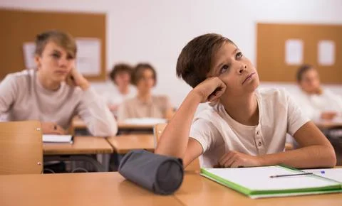 Boy feeling upset after getting bad mark at school Stock Photos