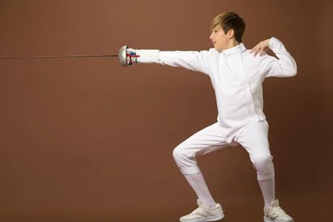 Boy fencer standing in attacking pose Stock Photos