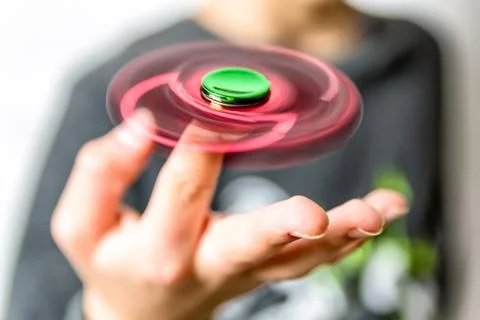 Boy with fidget spinner in hand Stock Photos