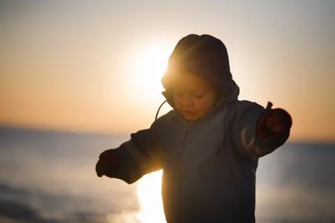 Boy on a field in sunset Stock Photos