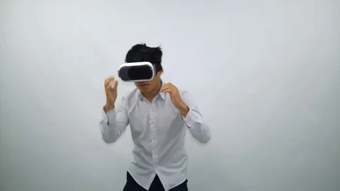Boy Fights in Virtual Reality Glasses on a White Background Stock Footage 71443825
