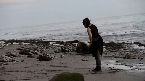 Boy finds shells to collect at the beach Stock Footage 83165755