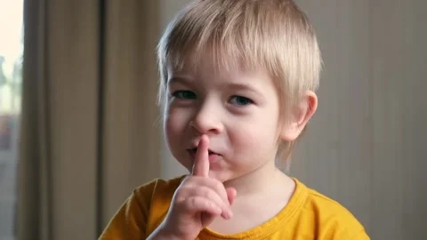 Boy with finger on lips. Child saying hu... | Stock Video | Pond5, image size:480x270