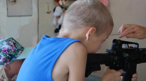 Boy Fires at Targets at a Shooting Range Machine Stock Footage 67601976