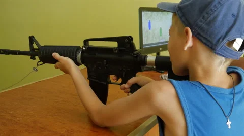 Boy Fires at Targets at a Shooting Range Machine Stock Footage 67602290