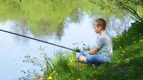 Young Fisherman. Boy in Yellow Jacket and Rubber Boots is Fishing while  Standing in Water on River Bank Stock Image - Image of pond, outdoor:  262471809