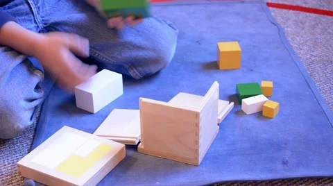 Boy Fitting Blocks into Wooden Box Puzzle Stock Footage 46639572