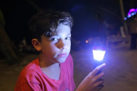 Boy with flashlight close up night ourdoor photo Stock Photos