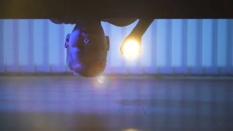 The boy with a flashlight looking under the bed. evening night time Stock Footage 90012228