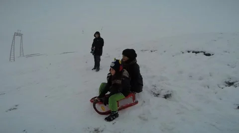 The boy floating in the snow in winter sleigh Stock Footage 45711459