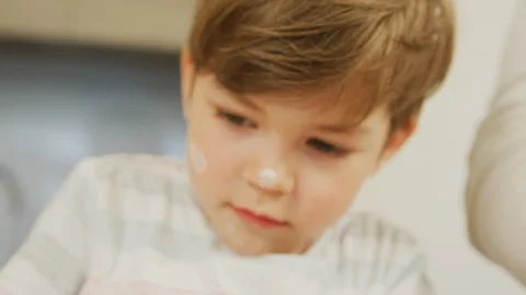 Boy with flour on face Stock Footage 100000865
