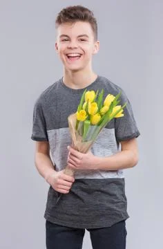 Boy with flowers on gray Stock Photos