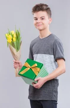 Boy with flowers on gray Stock Photos