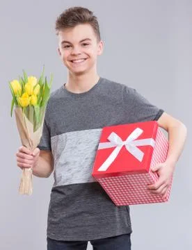 Boy with flowers on gray Stock Photos