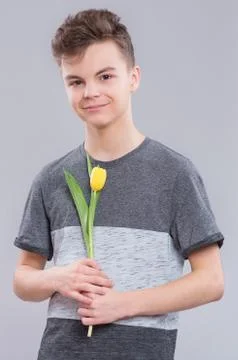 Boy with flowers on gray Stock Photos