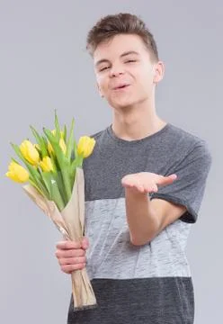 Boy with flowers on gray Foto stock
