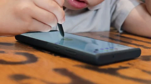 Boy focuses intently on drawing. Stock Footage 288976239