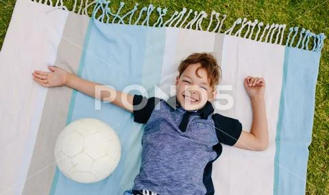 Boy with football enjoying in a park Stock Photos