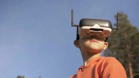 Boy in the forest uses VR virtual reality glasses and is amazed by nature Stock Footage 162396842