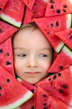 A boy framed by triangular pieces of watermelon.Cute portrait of a baby Stock Photos