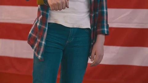 Boy in front of american flag holding a skateboard. shot in slow motion Stock Footage 75781396
