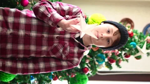 Boy in front of Christmas tree Stock Footage 145142295