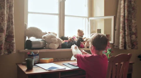 BOY IN FRONT OF THE DESK MAKING PARTY INVITATIONS Stock Footage 68755604
