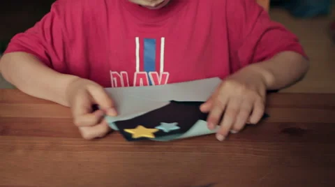 BOY IN FRONT OF THE DESK MAKING PARTY INVITATIONS Stock Footage 68755759