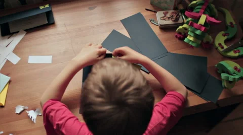 BOY IN FRONT OF THE DESK MAKING PARTY INVITATIONS Stock Footage 68755786