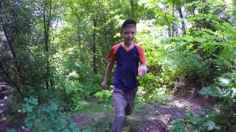 Boy fun walking and skipping on the forest path. Video stock 51490019