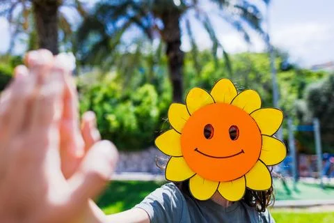 A boy in a funny mask is having fun with his friends. A boy is having fun o.. Stock Photos