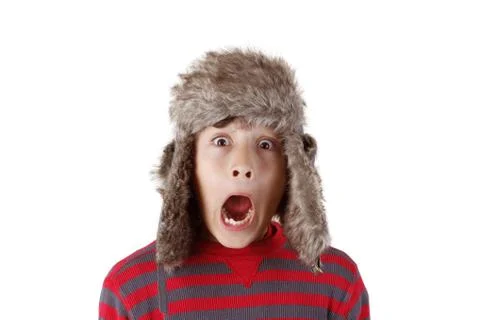 Boy in furry hat pulling funny faces Stock Photos
