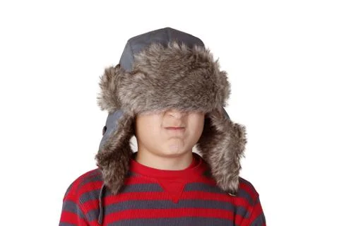 Boy in furry hat pulling funny faces Stock Photos