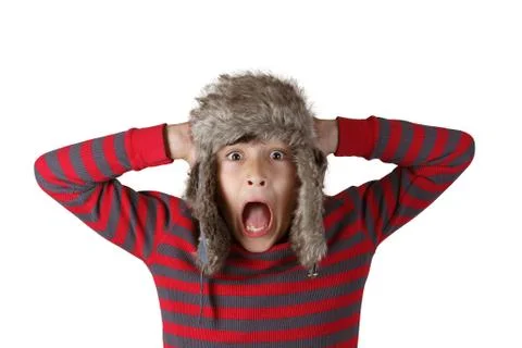 Boy in furry hat pulling funny faces Stock Photos