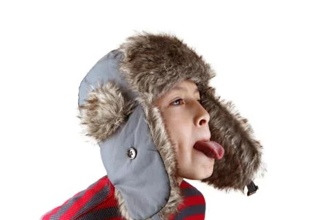 Boy in furry hat pulling funny faces Stock Photos