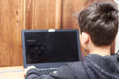 Boy gamer plays on the computer, playing a lot is harmful Stock Photos