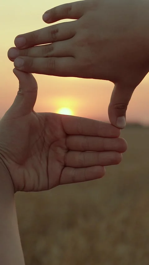 Boy gestures with fingers toward frame at sun. Kid sees it like in movie. Child Stock Footage 319345850