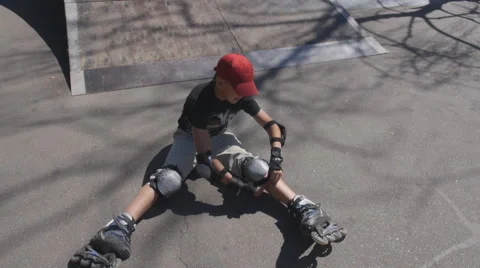 Boy gets up after a fall on roller skates 25 fpsmov Stock Footage 64791456