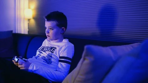 Boy gets frustrated while playing video game at home Stock Footage 98841687