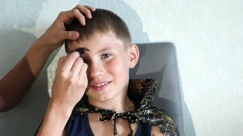 Boy getting his face painted for Halloween party. Copy space Stock Footage 158803499