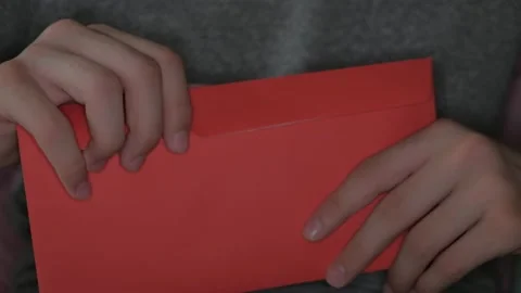 Boy is getting out russian rubles from red paper envelope traditional in China Video stock 132802226