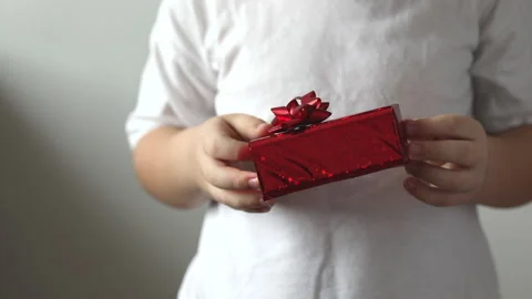 The boy give a red gift, Valentines day. Christmas gift. Stock Footage 147453039