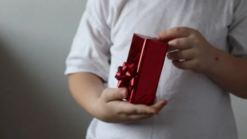 The boy give a red gift, Valentines day. Christmas gift. Stock Footage 147453071