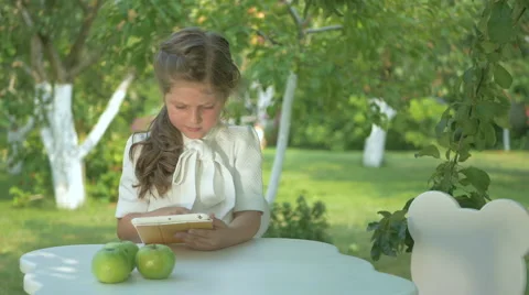 Boy gives a cute girl a flowers in the garden Stock Footage