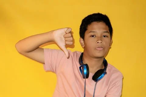 A boy is giving a thumbs-down. Stock Photos